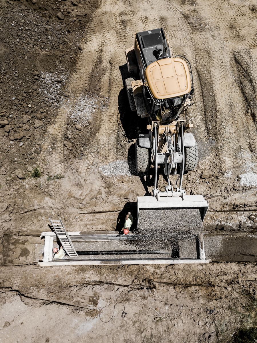Construction equipment dumping gravel